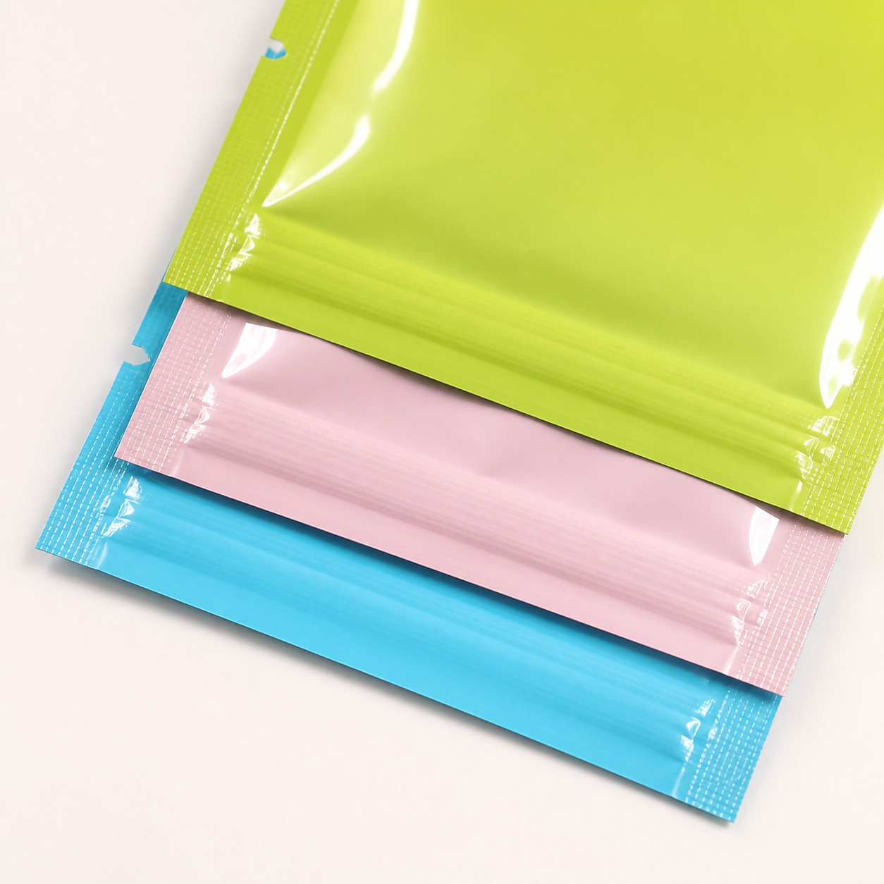Clean heat-sealed edges on stacked colorful pouches